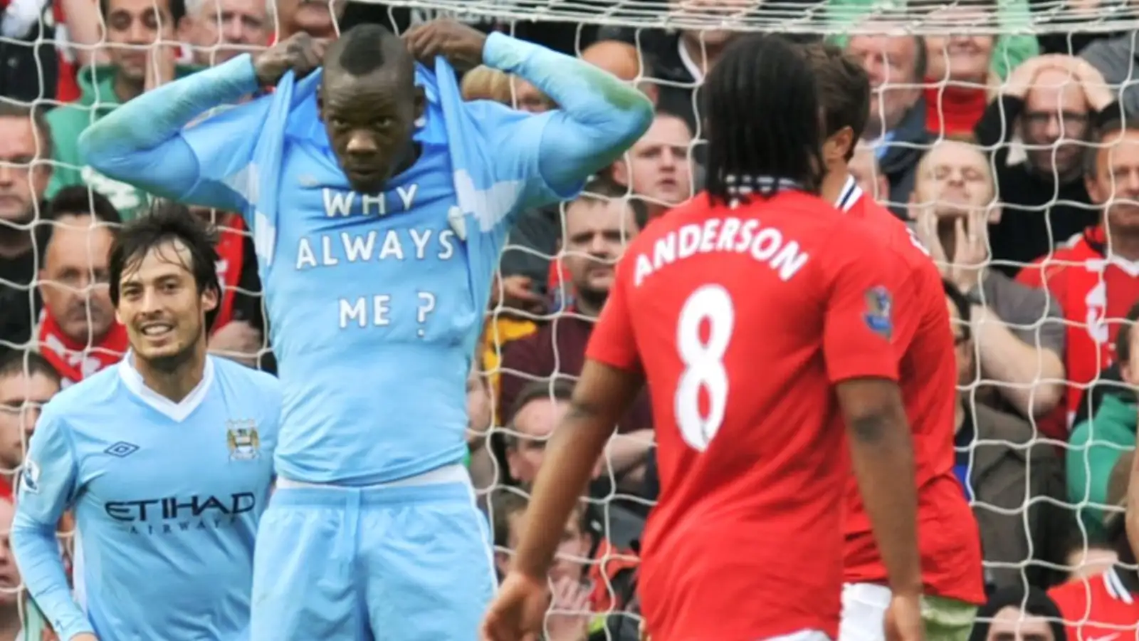 Mario Balotelli celebrates scoring against Manchester United by revealing a t-shirt with 'Why Always Me?' written on it.