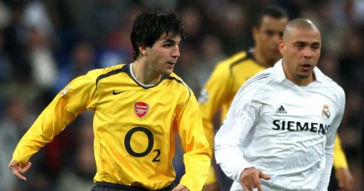 Arsenal's Cesc Fabregas is challenged by Real Madrid's Ronaldo as he passes to Thierry Henry who goes on to score the only goal of the game, during the Champions League second round 1st leg match in Madrid. 21st February, 2006, Santiago Bernabeu, Madrid.